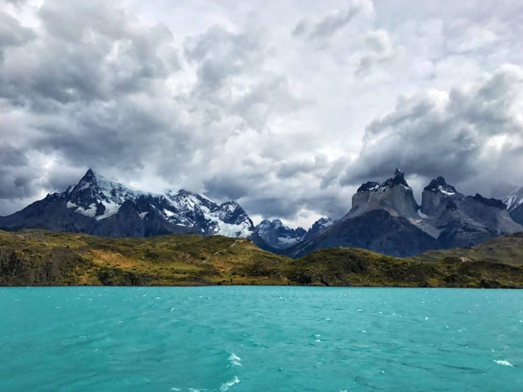 View of turquoise lake and mountains taken from catamaran in Torres del Paine