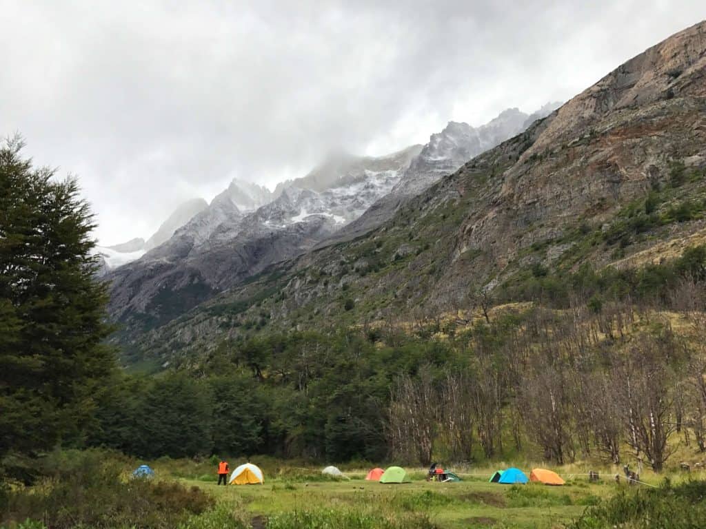 Tents set up with a mountain backdrop in Refugio Grey - Torres del Paine W Trek