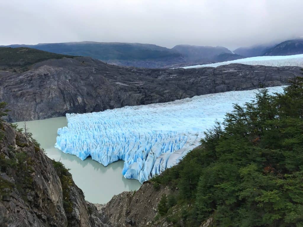 What to know before trekking the W, Bright blue Glacier Grey emerging from the rocks and mist