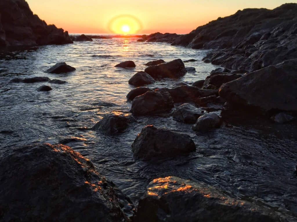 Montezuma sunrise on the ocean hitting the rocks