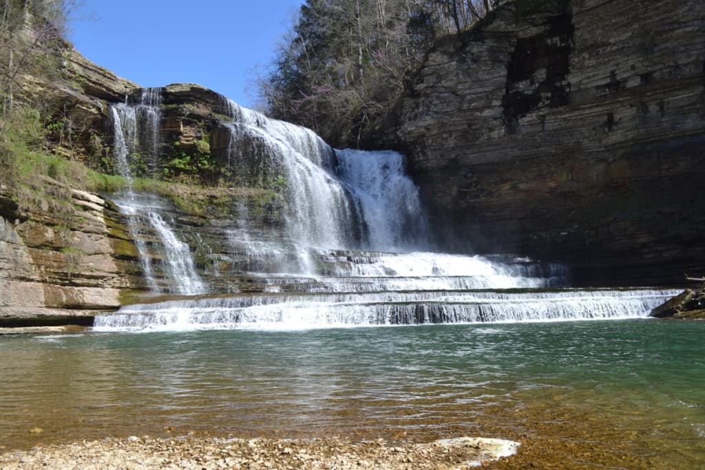 Cummins Falls near Nashville TN water cascading down rocks into an emerald pool