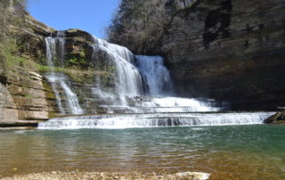 Cummins Falls near Nashville TN water cascading down rocks into an emerald pool