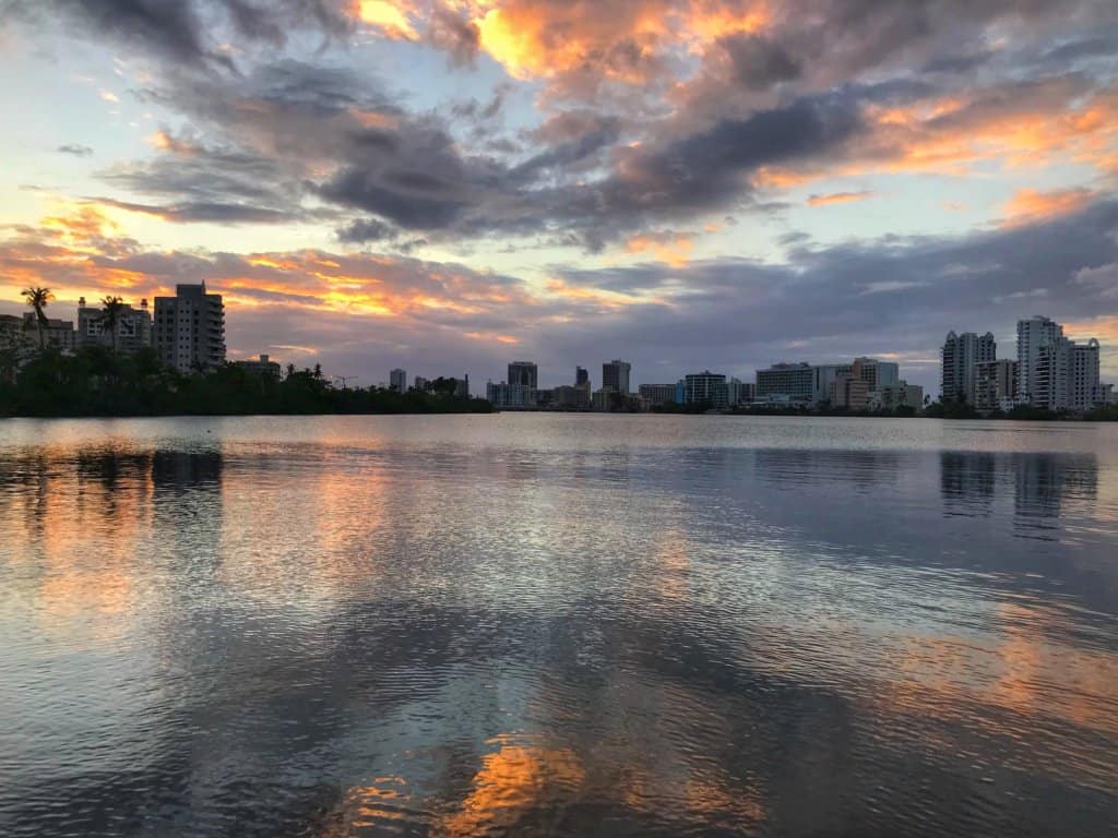 Sunset at Condado Lagoon, orange clouds reflecting off the calm water