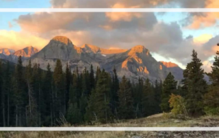 campgrounds in glacier national park header, mountains with sun hitting them