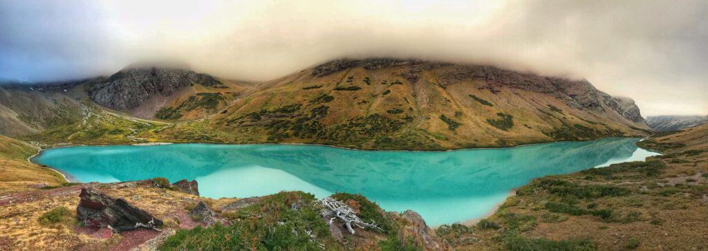 Turquoise Cracker Lake surrounded by fog