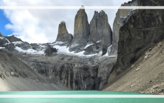 The Torres del Paine with glimmering aquamarine water at the base