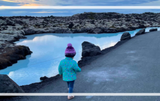 Tips for Iceland Travel with a toddler header, Blue Lagoon midnight sun with toddler