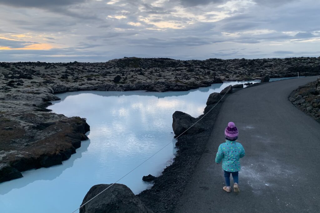 Turquoise water cloud reflections at The Blue Lagoon Iceland with a toddler