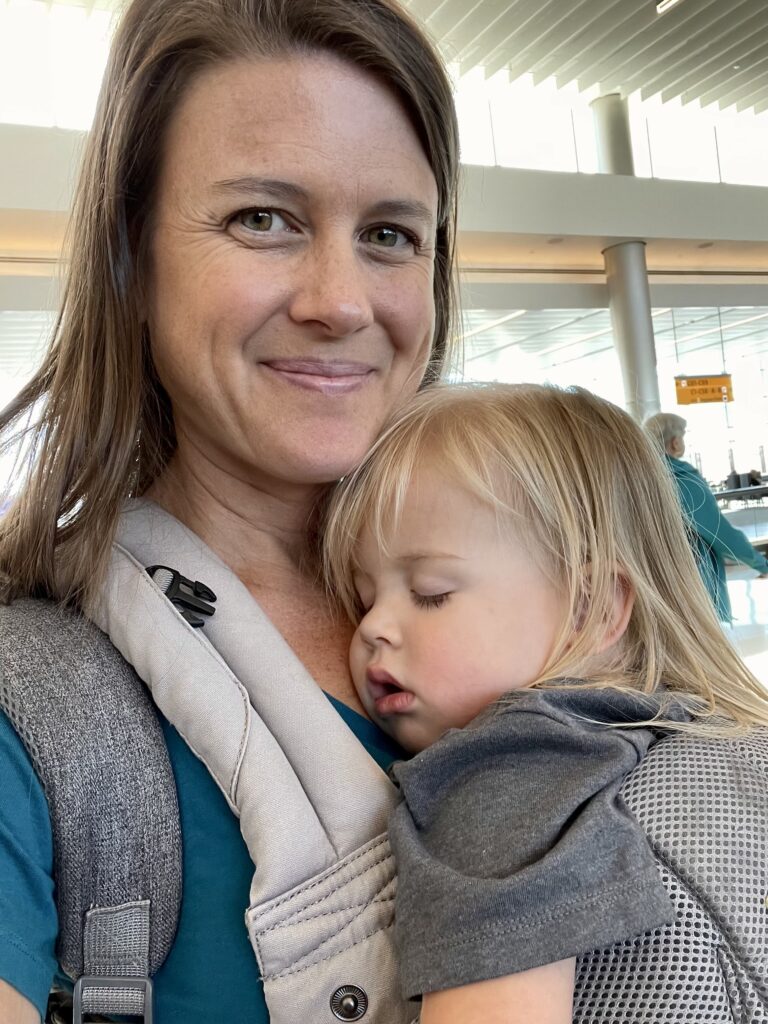 Toddler sleeping in Lille carrier at airport