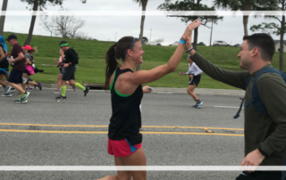 woman high fiving during marathon