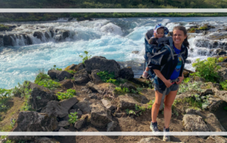 Toddler Travel Essentials featured toddler in hiking backpack in front of waterfall