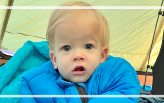 How to keep a toddler or baby warm while camping in cold weather featured image baby in sleeping bag