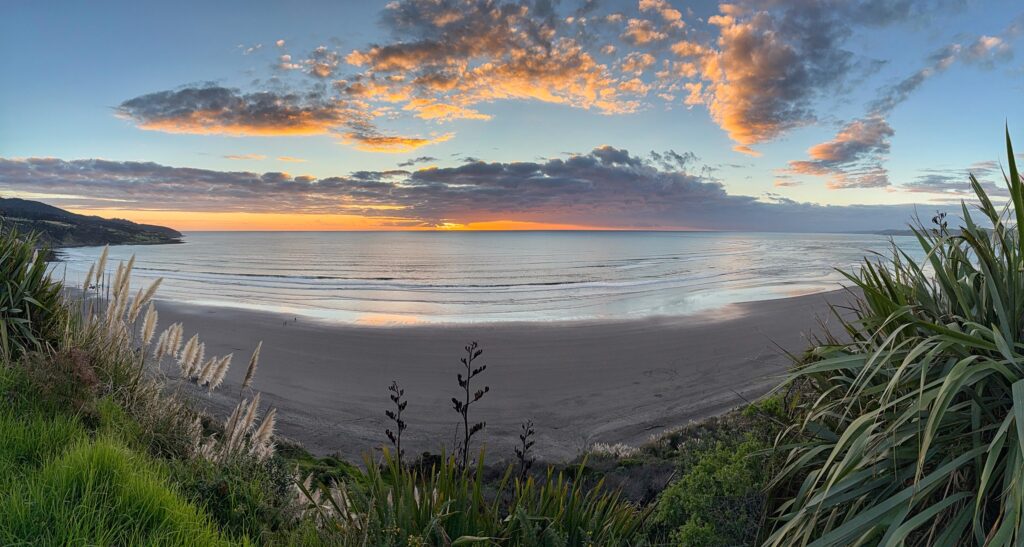 New Zealand Ngarunui Beach at sunset