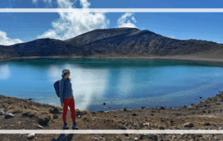 solo traveler looking out at crater lake in new zealand
